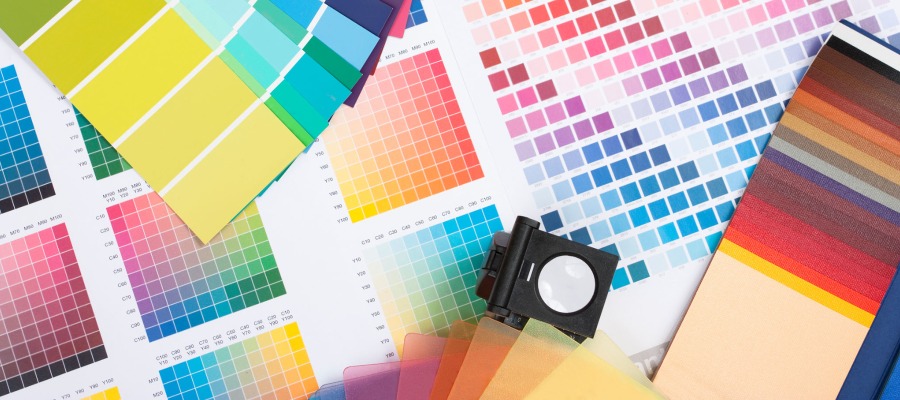Photo of a photographer's loop and a variety of color cards used by printers.