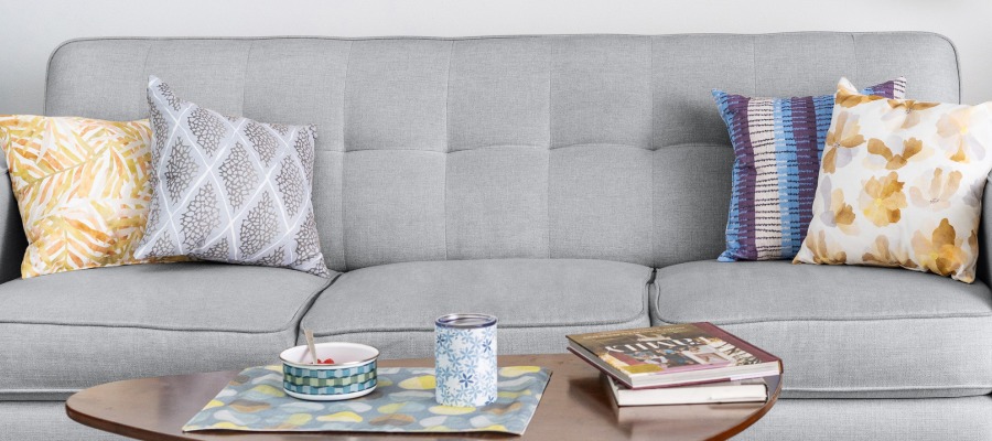 Couch with four different pillows customized with different fabric.