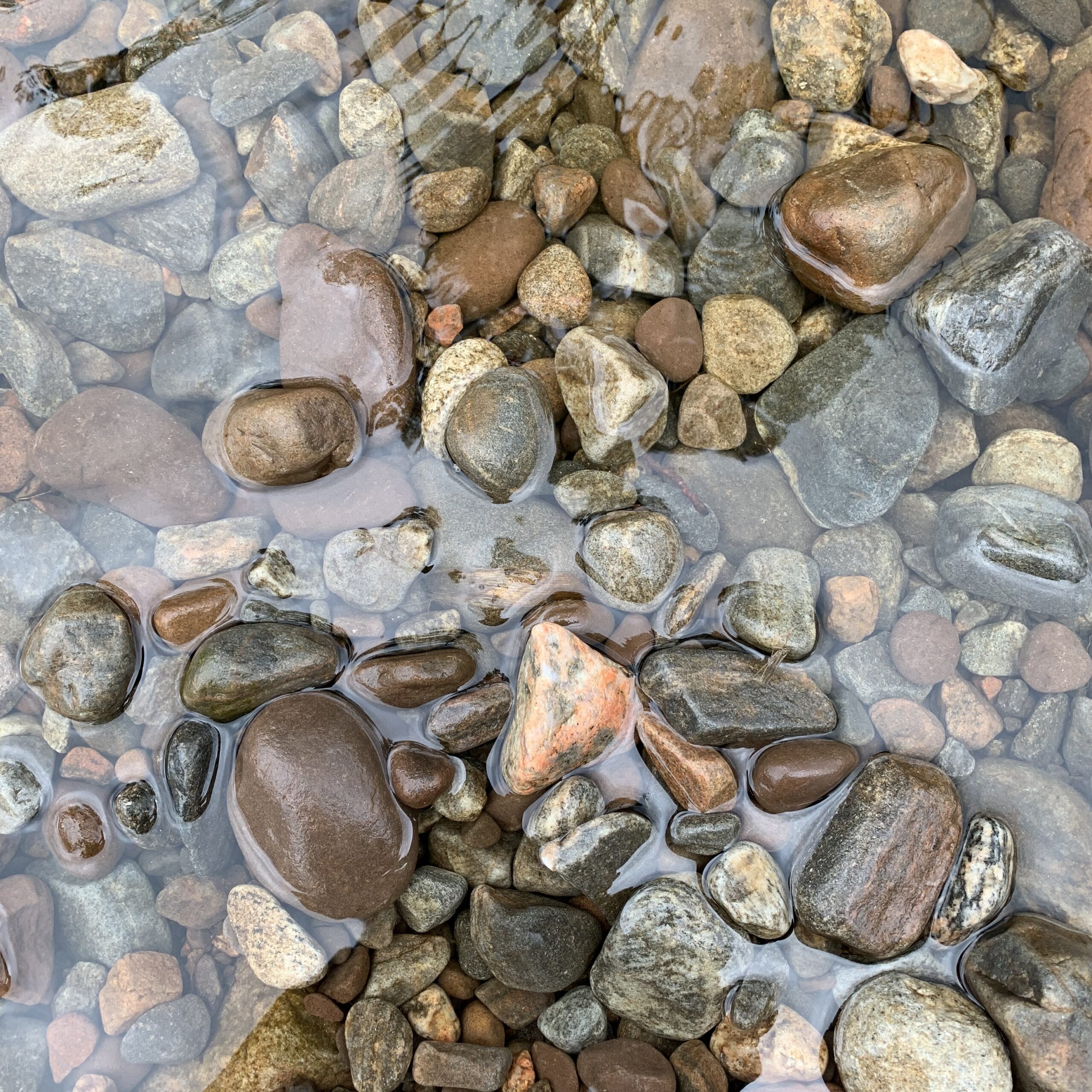 Photo of rocks slightly underwater.