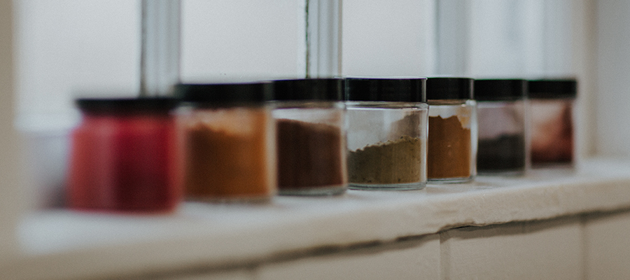 Canisters of natural dye powder in a row lined up on a windowsill.|Close up of Kristen Dettoni's hands working on punch needle artwork.|Two images of original punchneedle artwork created by Kristen Dettoni