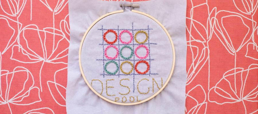 Embroidery hoop with Design Pool logo embroidered inside.|