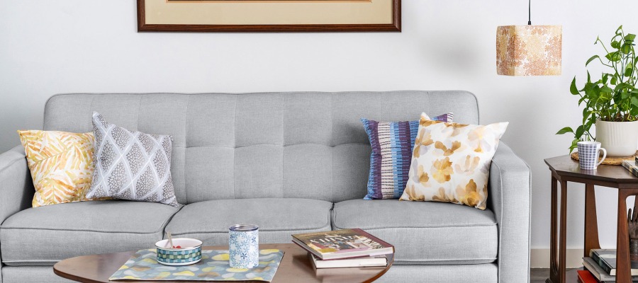 Living room scene with couch and pillows. All props are printed with Design Pool patterns and available through Domanda Design.