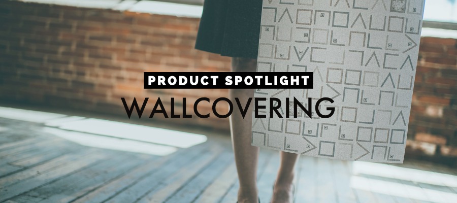 Photo of woman in mill space holding a piece of wallcovering. Words read Product Spotlight Wallcovering|Grid of 11 icons with names of different materials. The icon for wallcovering