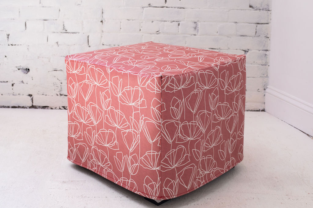 Design Pool pattern String Together printed on upholstery and photographed covering a square ottoman.