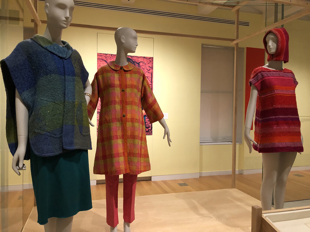 A photo taken at the Cooper Hewitt of three mannequins wearing garments made from Dorothy Liebes textiles.