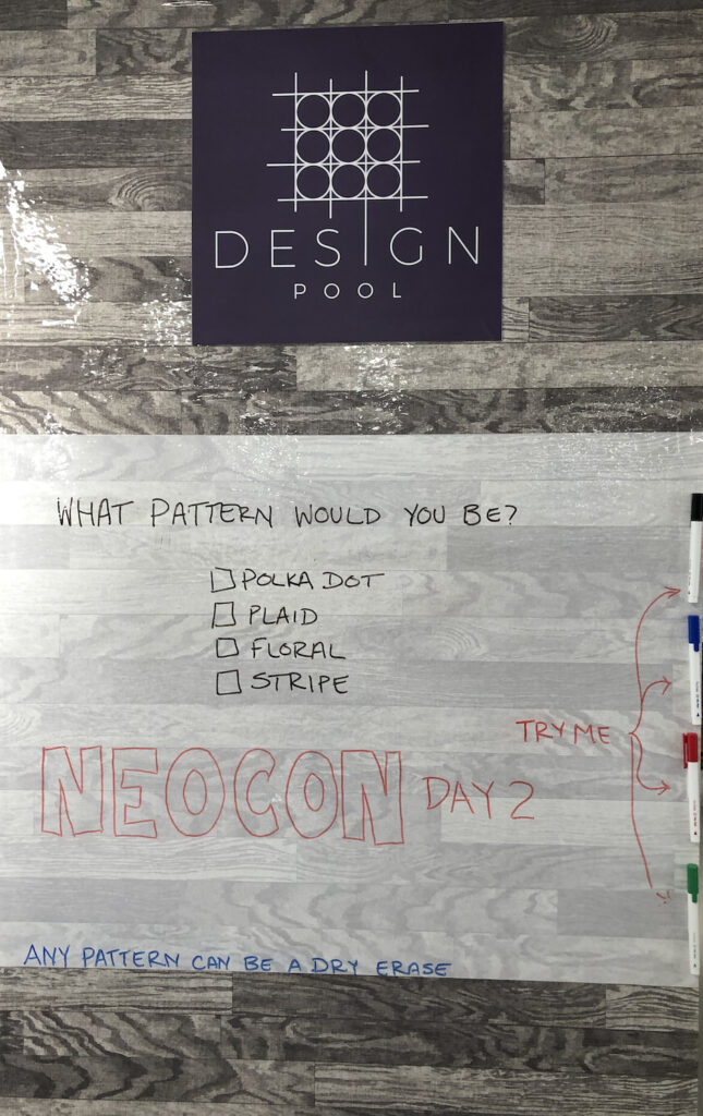 Photo taken in Design Pool's booth at NeoCon showing an example of Graphix Unlimited's dry erase wallcovering.