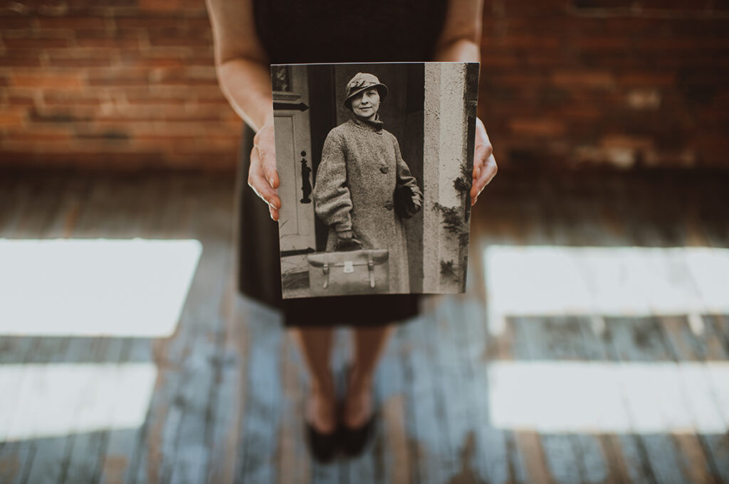 Woman holding a photo of Elizebeth Smith Friedman.